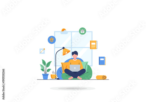 Young man working remotely on a laptop computer while relaxing on a bean bag chair with a desk lamp and plant nearby in a cozy home office setting