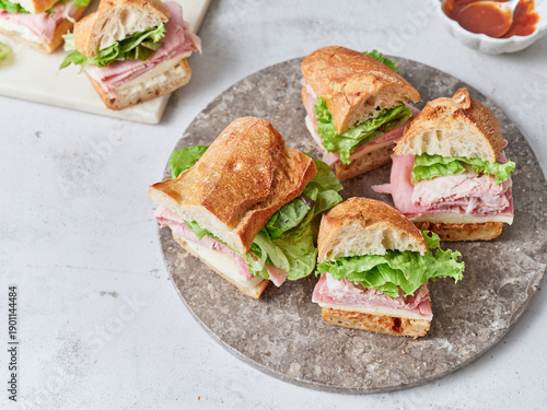 Delicious baguette sandwiches with fresh ingredients on a lunch table