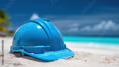 Blue Hard Hat on Sandy Beach with Turquoise Water and Palm Trees Under Clear Sky in Bright Daylight