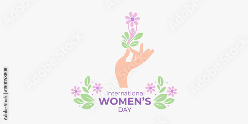 Hand holding a flower with International Women's Day lettering. Gender equality and female empowerment concept.