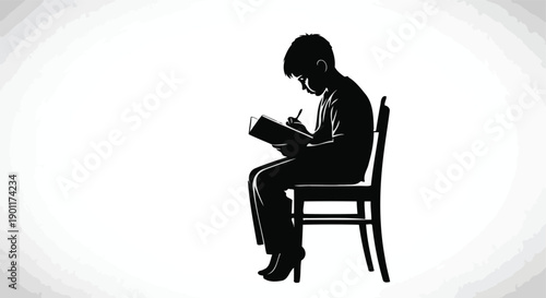 Silhouette of a young boy sitting on a chair and writing in a book with a pen.