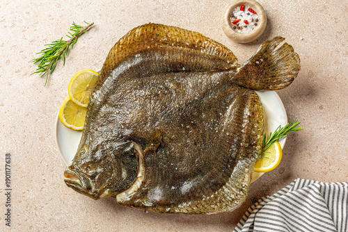 Tableau sur toile Cooked, oven baked  Whole Turbot fish in a plate, with lemon and rosemary