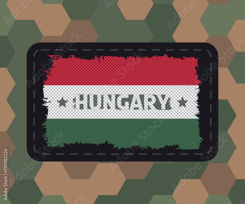 Tactical army textile chevron patch with the flag of Hungary on army camouglage background
