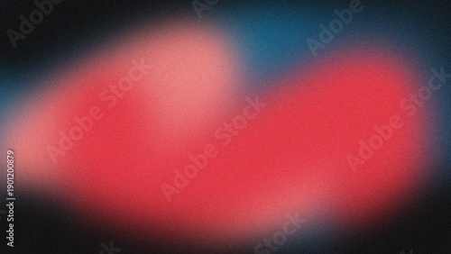 Blurry red heart shape on dark surroundings captured in a close-up photograph