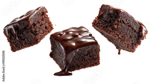 Three rich chocolate brownies, one heavily drizzled with thick, glossy dark chocolate sauce