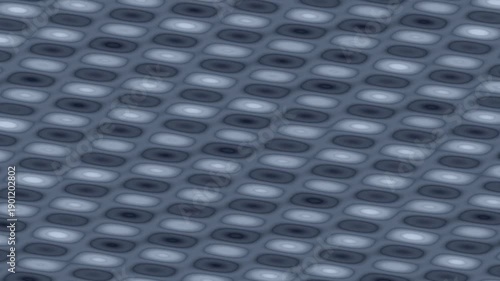 A smooth, textured surface displaying a pattern of elongated ovals in varying shades of gray