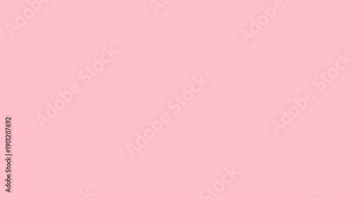 A solid pastel pink background with a smooth, uniform texture