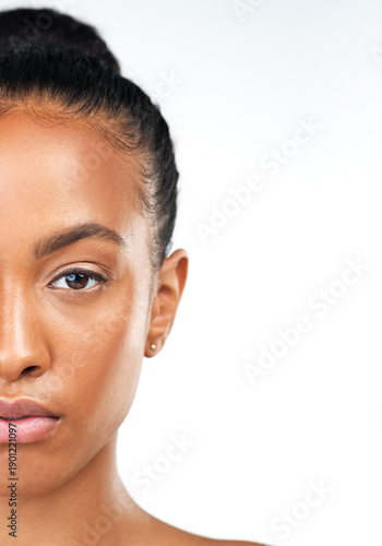 Fotografi Black woman, half face and skincare in studio, confident and beauty on white background