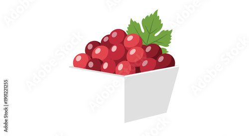 Plump red grapes topped with a single green leaf overflowing from a simple white container, ready to be served.