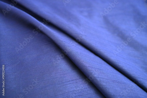 Foto Soft folds of luxurious blue fabric texture