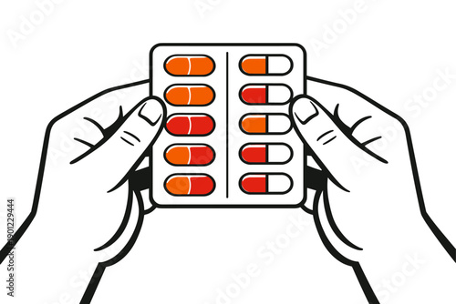 Hands holding blister pack of red and orange capsules