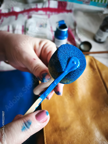 A Housewife Renewing Her Bag with Leather Dye at Home and Changing Its Color. Do it yourself (DIY) project