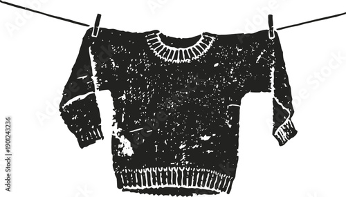 Worn sweater hanging on clothesline with torn patches and frayed edges