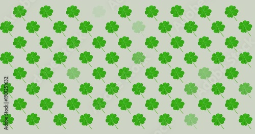 Digital animation of multiple clover leaves flickering against grey background