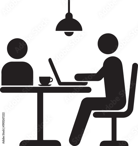 Silhouette of man working on laptop in cafe