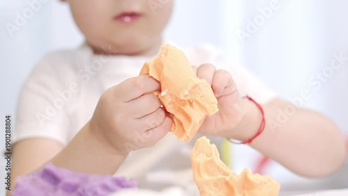 Toddler hands playing with modeling clay