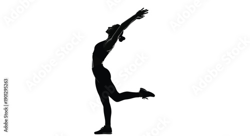 Silhouette of a woman performing a challenging balance and stretching exercise in athletic attire
