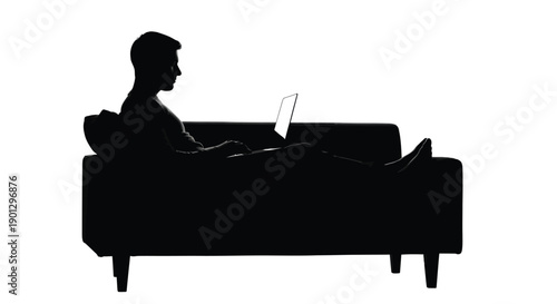 Silhouette of a man relaxing comfortably on a couch while working remotely on a laptop computer