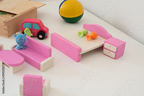 Pink doll house furniture and small plastic dolls