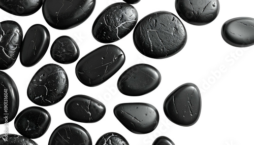 Smooth, black river stones on a black background; varied shapes and textures