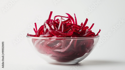 Sliced beetroot strips in transparent glass bowl on white background