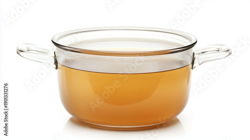 Meat broth in transparent glass saucepan isolated on white background