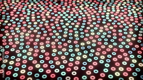 Colorful dots on black background with pink, blue and yellow circles