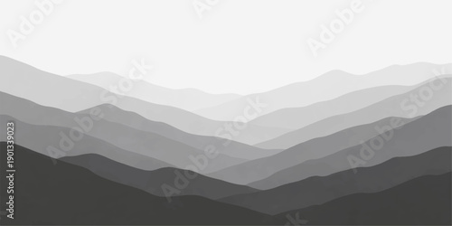 A serene mountain landscape at dawn features a blue mist veiling the forest hills and valley as the sun rises over the horizon, casting a haze across the distant range under a cloudy sky