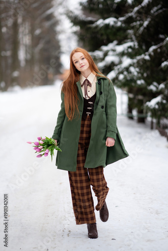 Red Haired Young Woman Holding Pink Tulips in Snowy Winter Forest, Seasonal Portrait