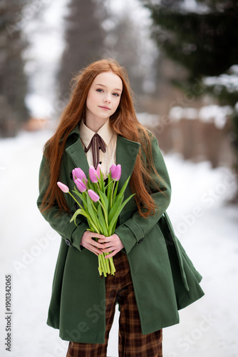 Red Haired Young Woman Holding Pink Tulips in Snowy Winter Forest, Seasonal Portrait