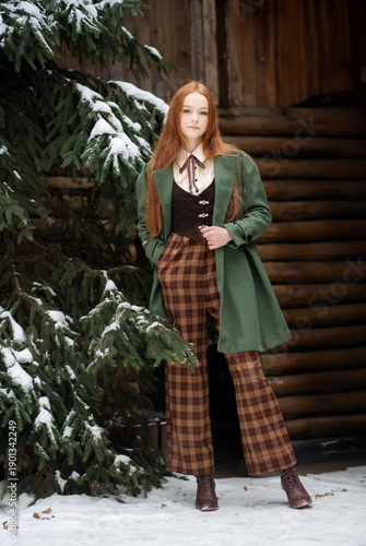 Red Haired Young Woman in Green Coat Standing in Snowy Winter Forest, Classic Portrait