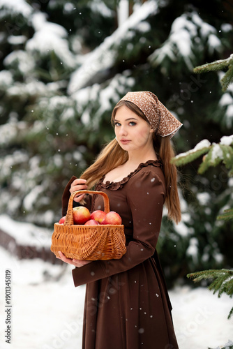 Young Woman Holding Basket of Apples in Snowy Winter Forest, Rustic Lifestyle Portrait