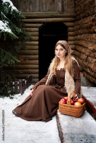 Young Woman Holding Basket of Apples in Snowy Winter Forest, Rustic Lifestyle Portrait