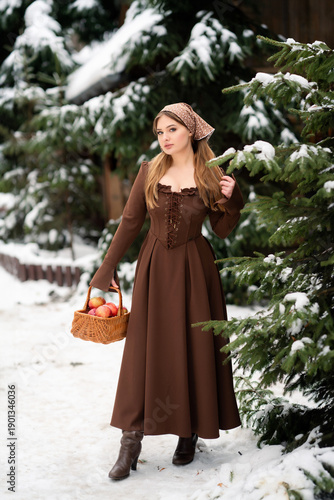 Young Woman Holding Basket of Apples in Snowy Winter Forest, Rustic Lifestyle Portrait