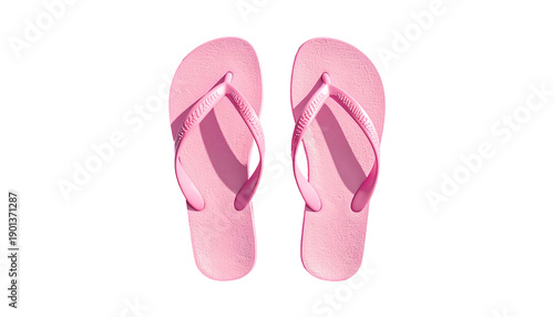 Overhead shot of two pink flip-flops isolated on a black background, with shadows