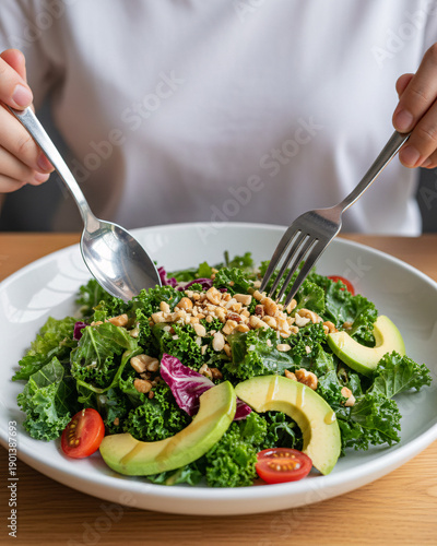 POV First-Person View of Hands Holding Spoon and Fork Over Fresh Salad Plate in Modern Pizza Restaurant