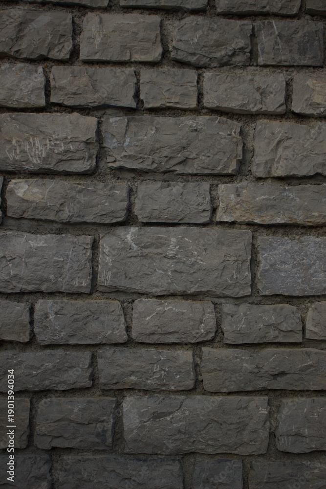 Obraz premium Old grey stone wall texture background, rough masonry architecture surface