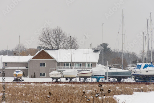 Schilderij op canvas Snow-Covered Marina with Boats in Winter