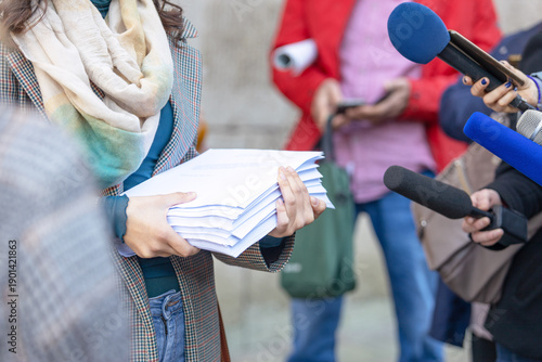 Tableau sur toile Whistleblower holding documents giving statement at press conference, speaking t