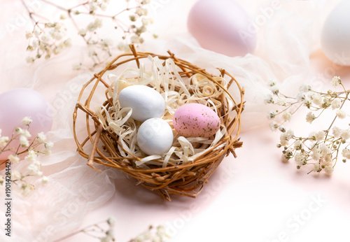 Beautiful eggs in nest soft pink colors composition.Easter holiday banner.