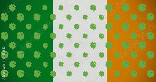 Digital animation of multiple clover leaves moving against irish flag