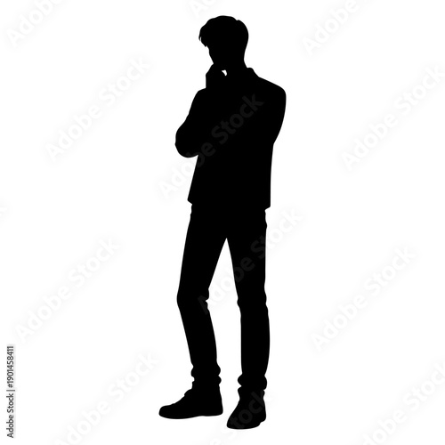 Silhouette of a young man standing in a thinking pose with hand on chin; contemplative male student or businessman looking for a solution.