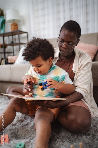 Wallpaper Mural Mother and child reading book and playing at home Torontodigital.ca