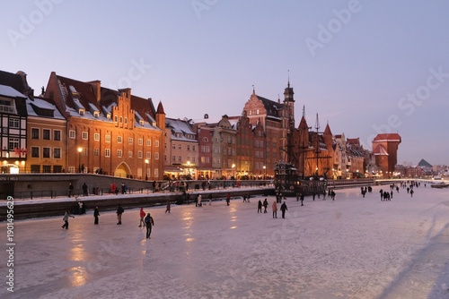 Wallpaper Mural Frozen Motlawa River in Old Town of Gdansk in evening scenery and a lot of people walking on ice.  Torontodigital.ca