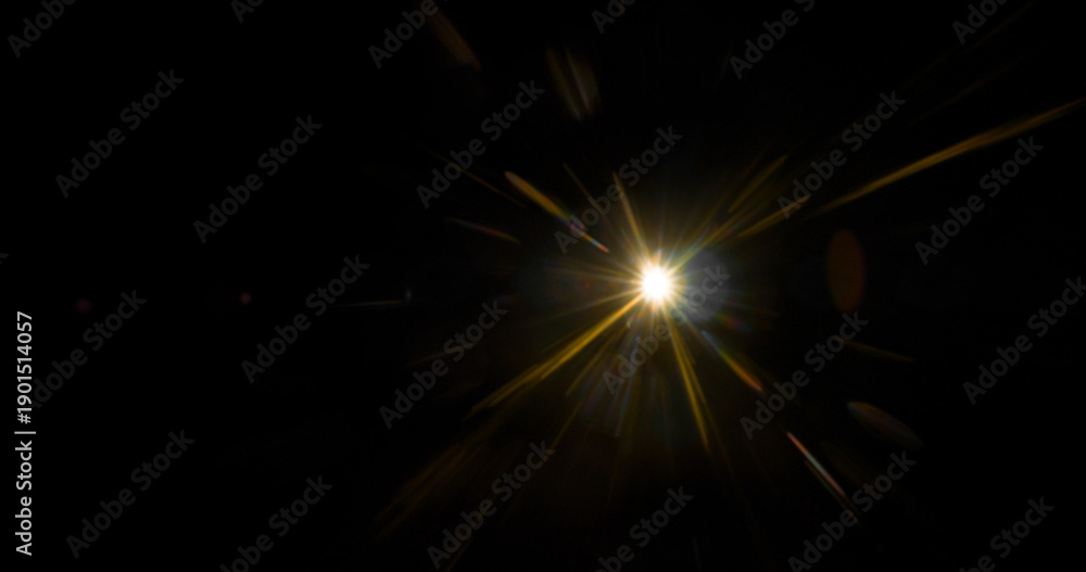 Fototapeta premium Abstract cinematic lens flare with bright light burst and star rays, isolated on black background. Optical light effect ideal for VFX overlays, transitions, titles and dramatic visual accents.