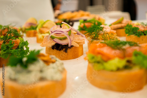 A variety of appetizers are displayed on a table, including some with onions