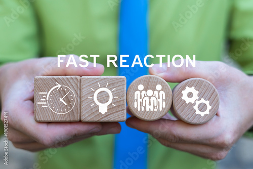 Fényképezés Business person holding wooden blocks with icons sees the text FAST REACTION