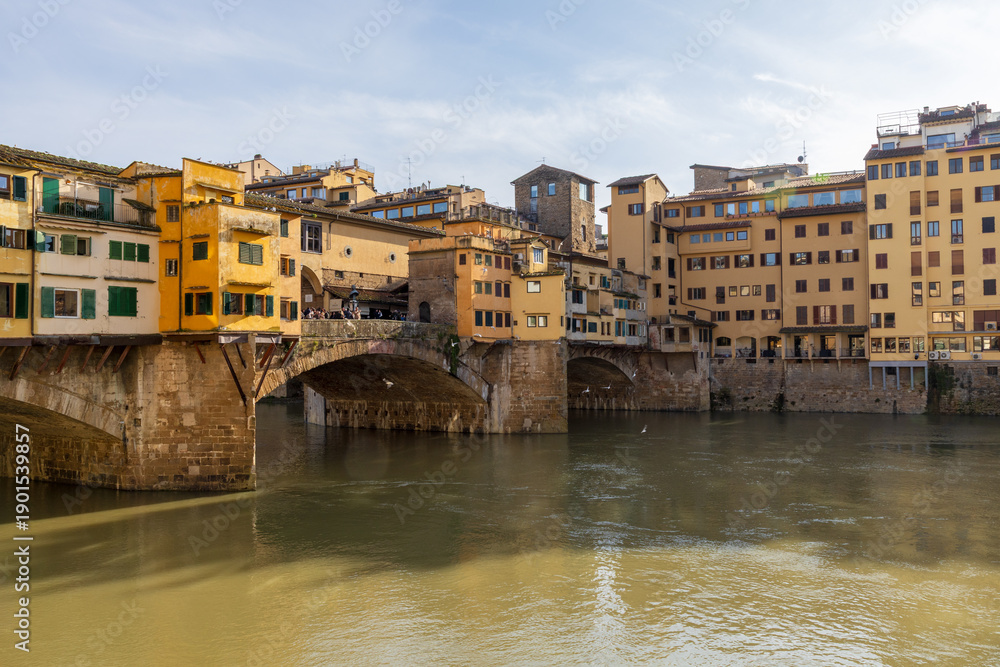 Fototapeta premium Peaceful Florence River View. Calm Waters Reflect Historic Architecture Scene. Gentle Reflections On Arno With Peaceful Historic Surroundings