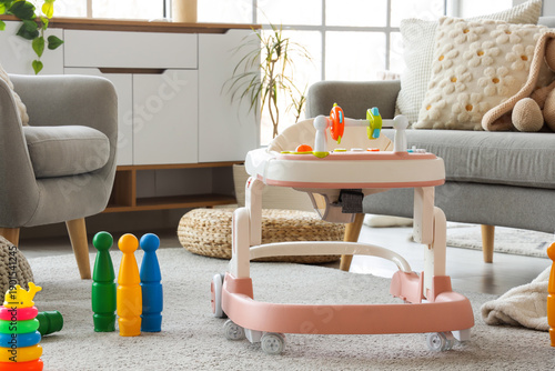 Baby walker with toys on ca...