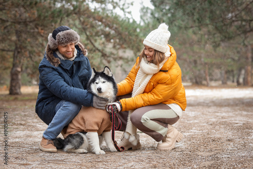 Young couple with Husky dog...